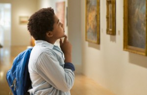 boy looking at painting